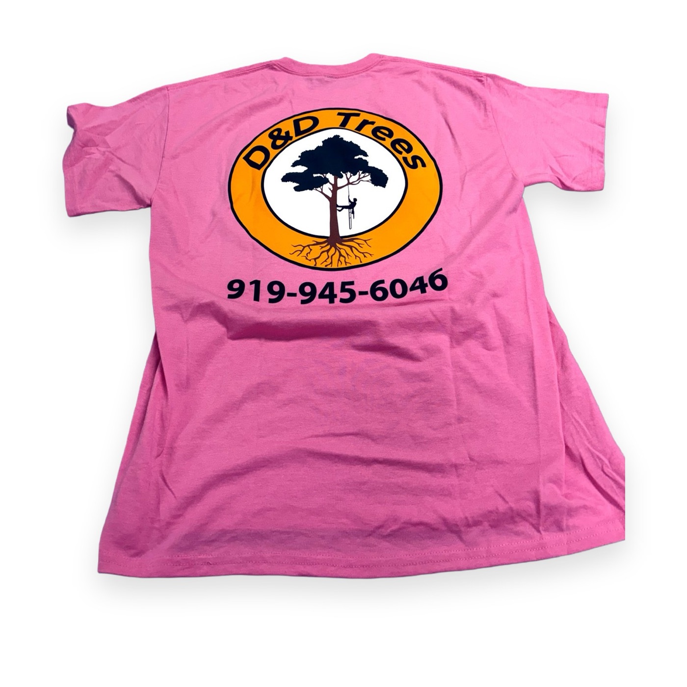 Bright pink tee with a large D&D Trees logo and phone number on the back