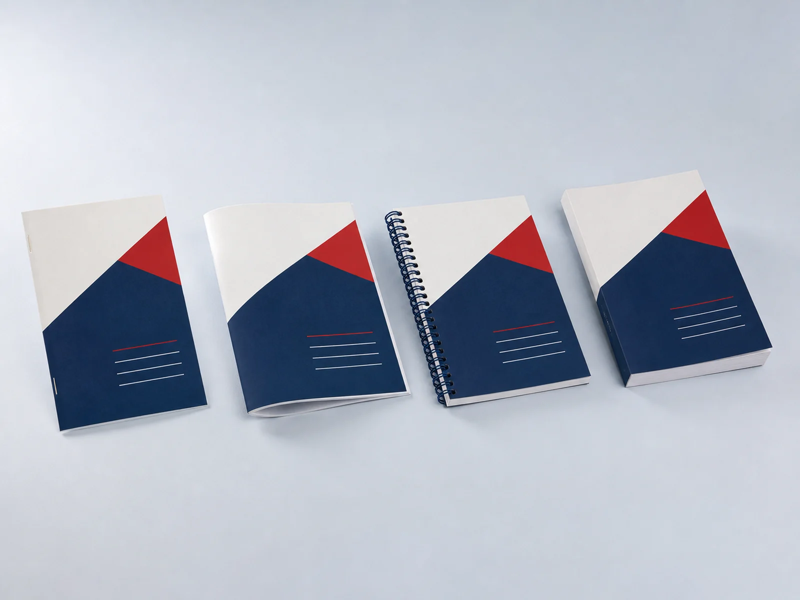 Saddle stitched, coil bound, and perfect bound books side by side