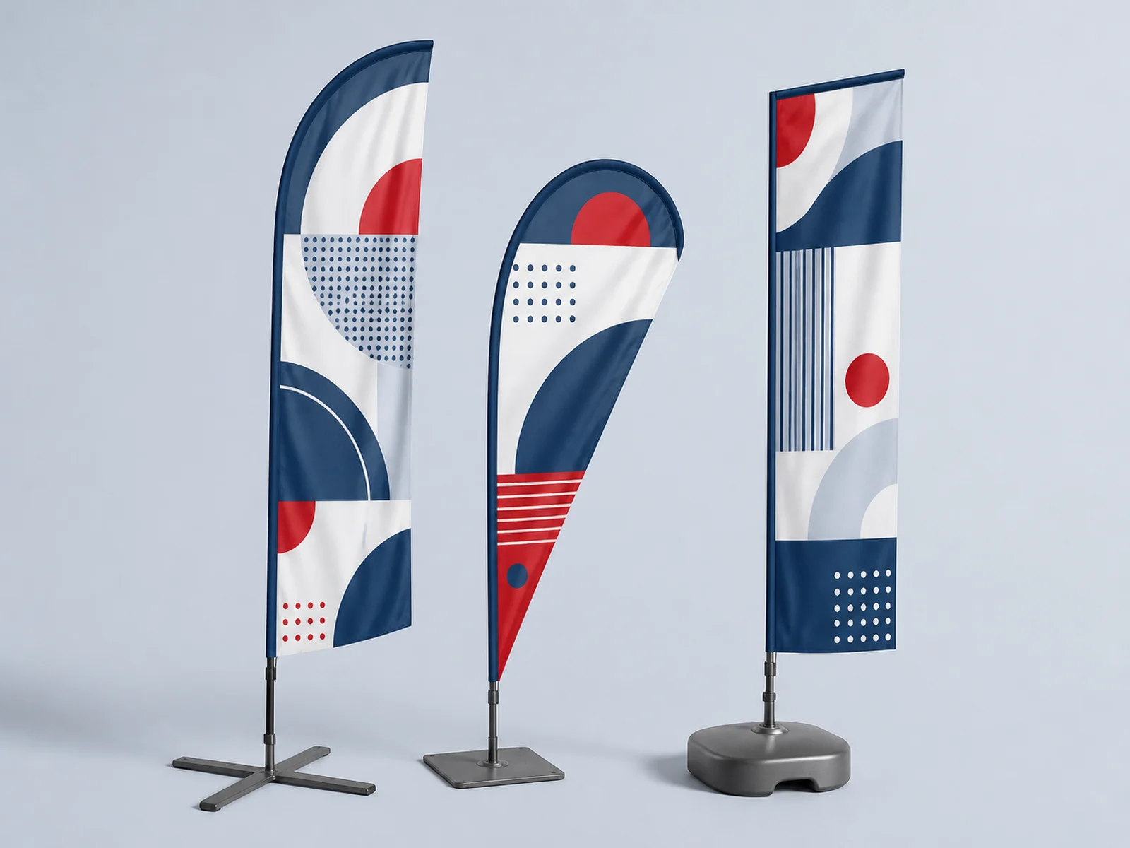 A feather flag, a teardrop flag, and a straight blade flag standing side by side