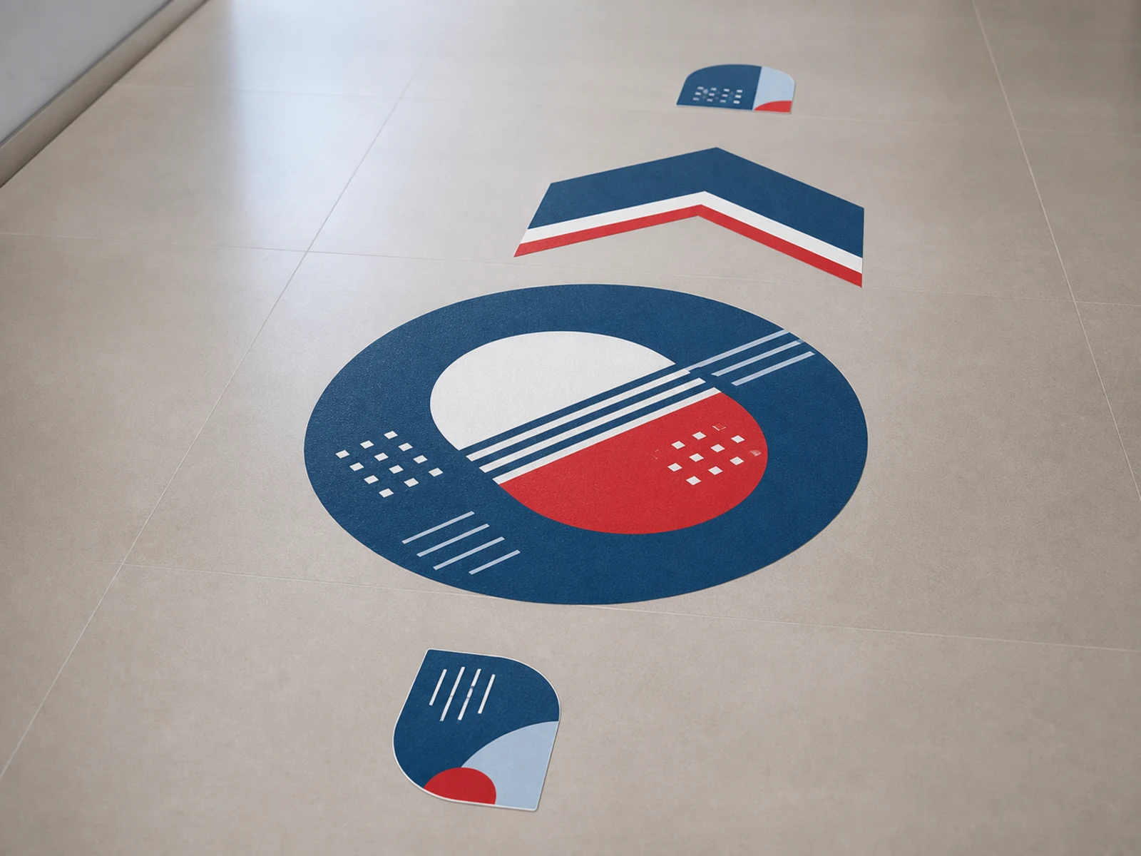 Anti slip floor graphics in circle, chevron, and contour cut shapes on a tile floor