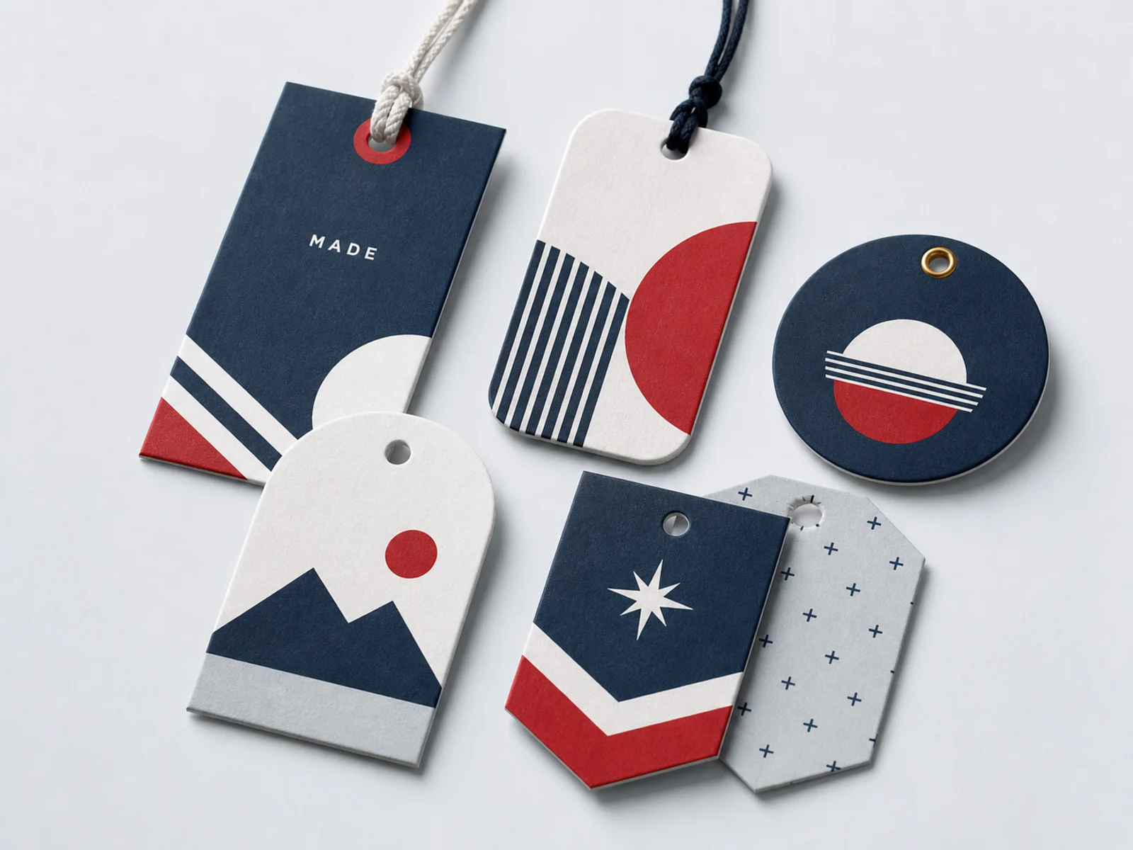 Five die cut hang tags strung with cotton string, twine, elastic, and ball chain