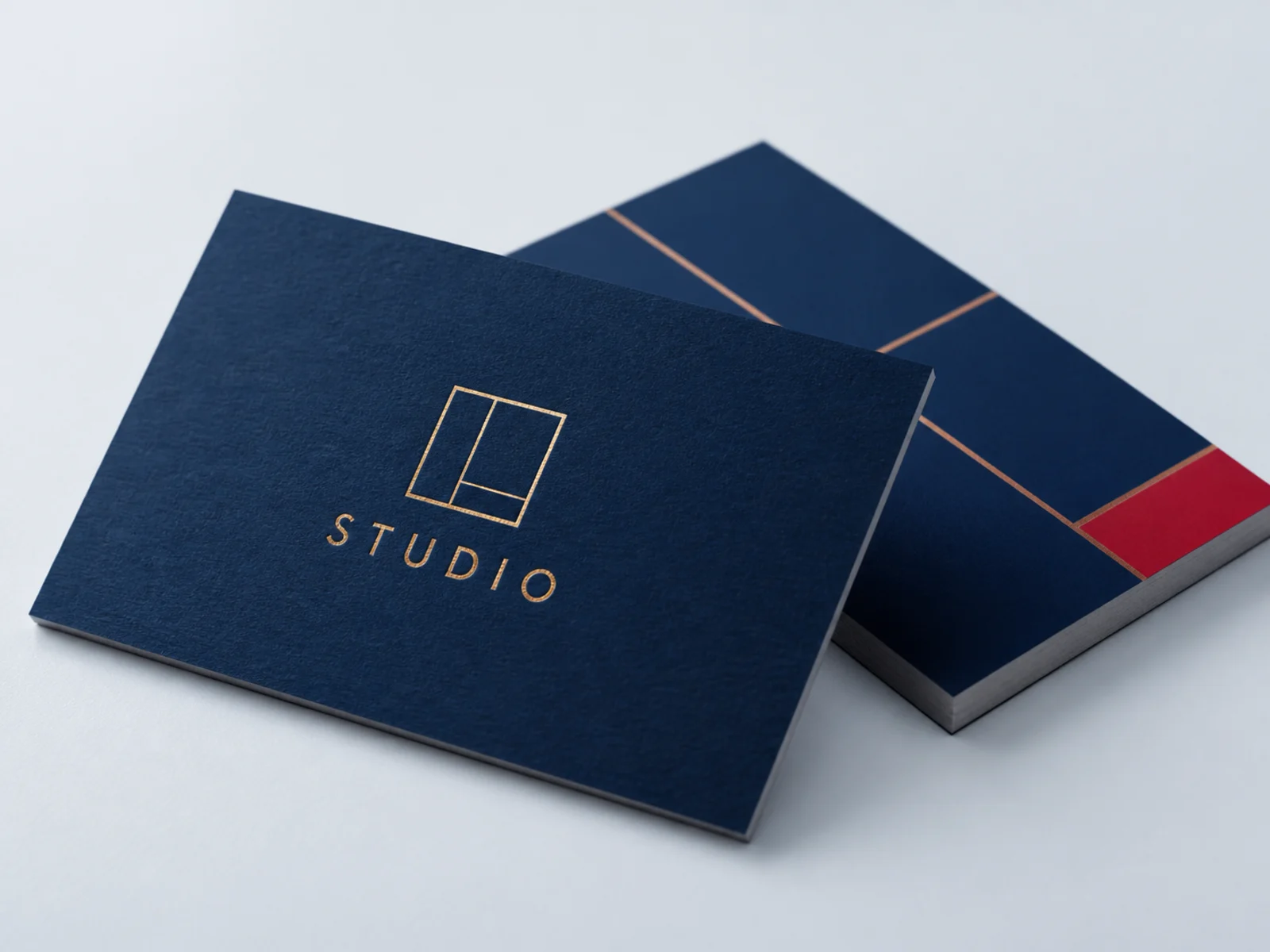 Gold foil catching the light across a navy business card