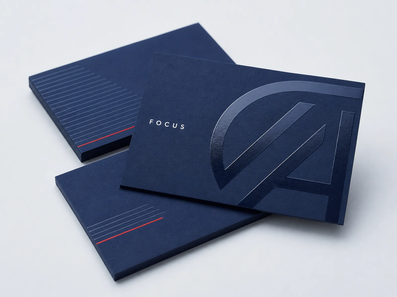 Raised spot gloss UV on a matte laminated card under raking light