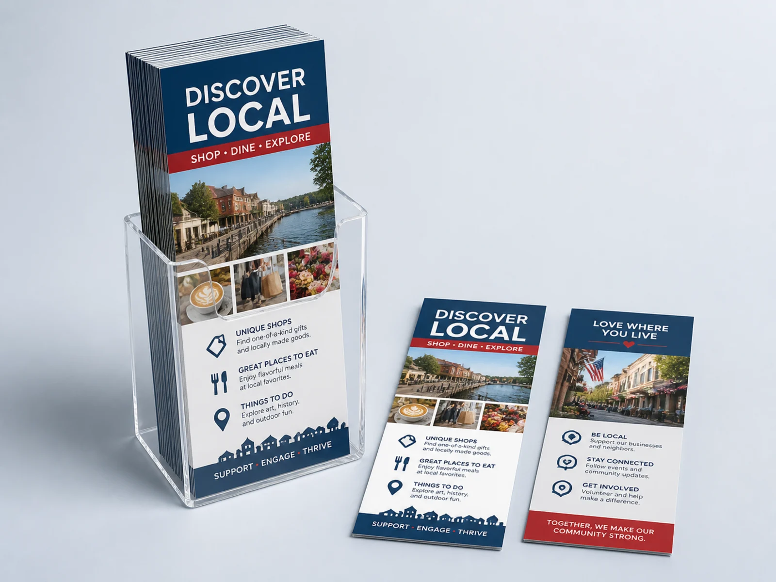 Three rack cards standing in a clear acrylic counter holder