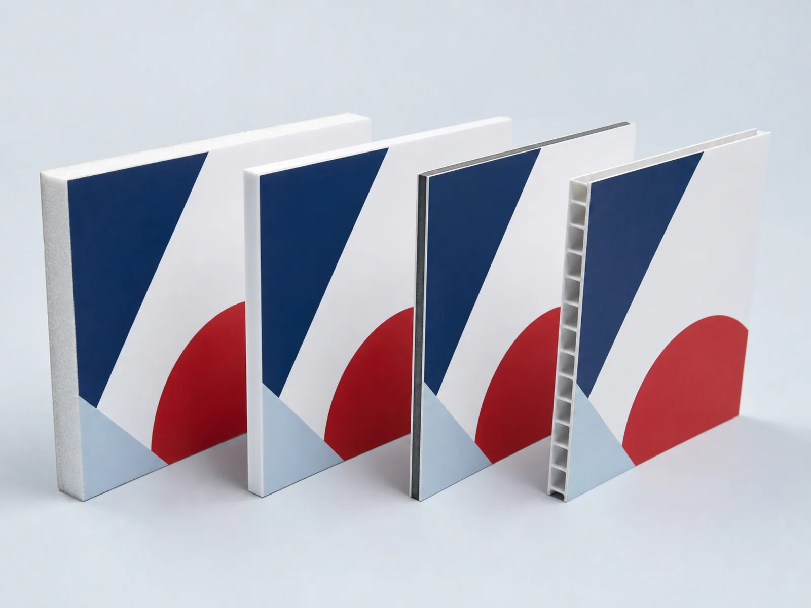 Four rigid substrates stood on edge showing coroplast flutes, PVC, foam core, and aluminum