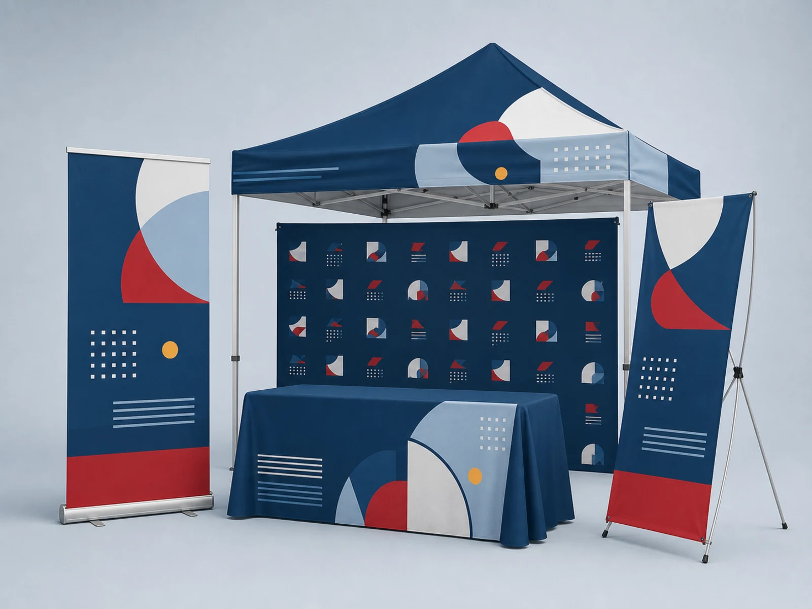 An event booth with a retractable stand, X-stand, table throw, pop-up tent, and step-and-repeat backdrop